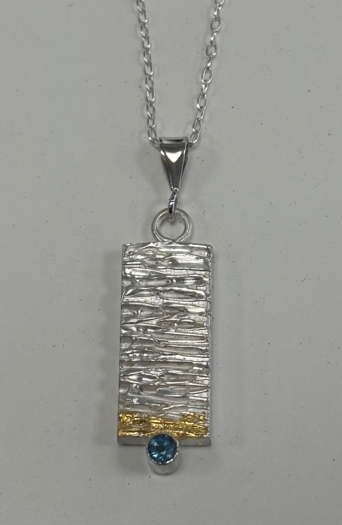 Sterling silver & 24ct gold pendant.